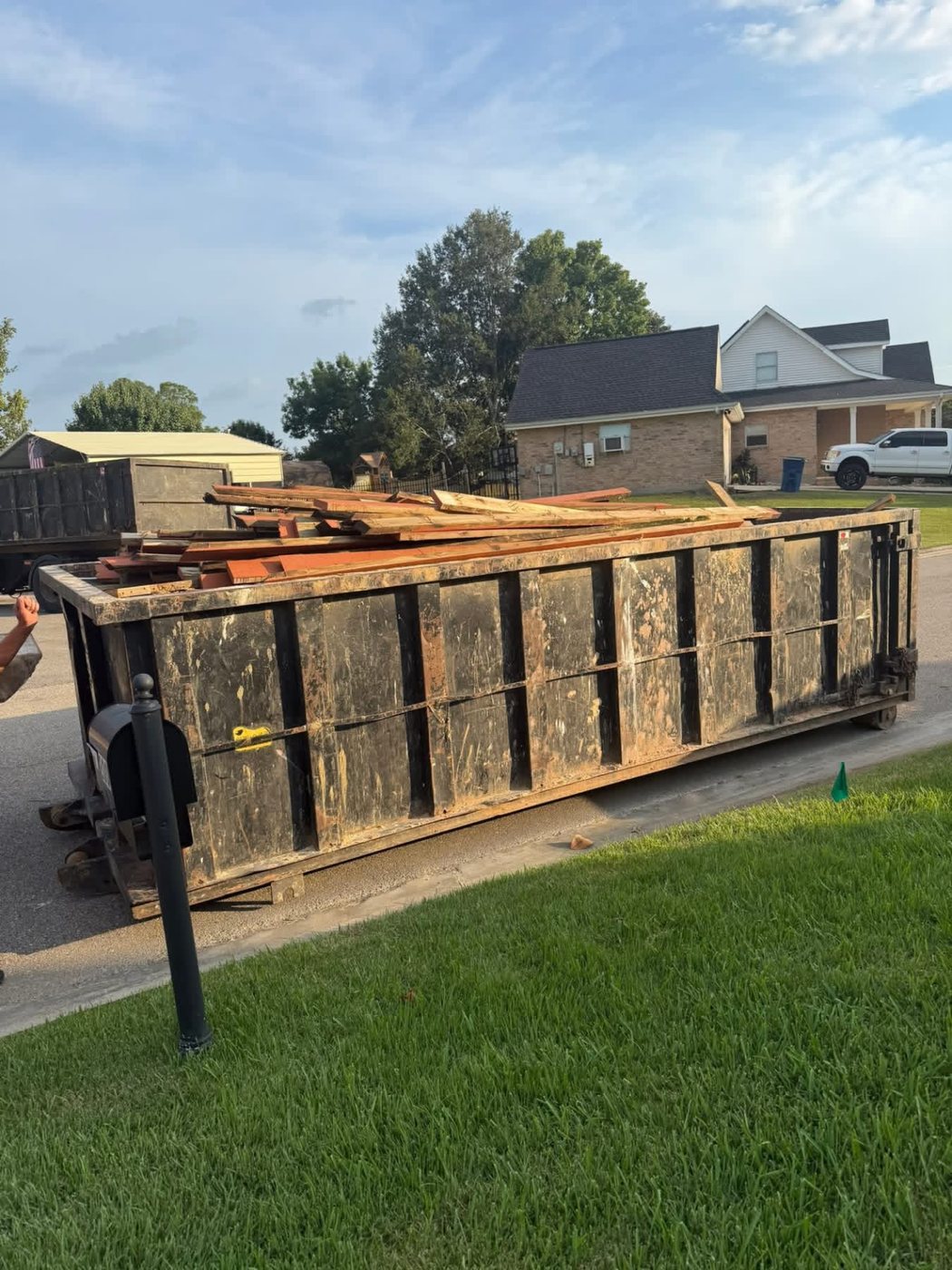 Demolition debris loaded into a roll-off dumpster