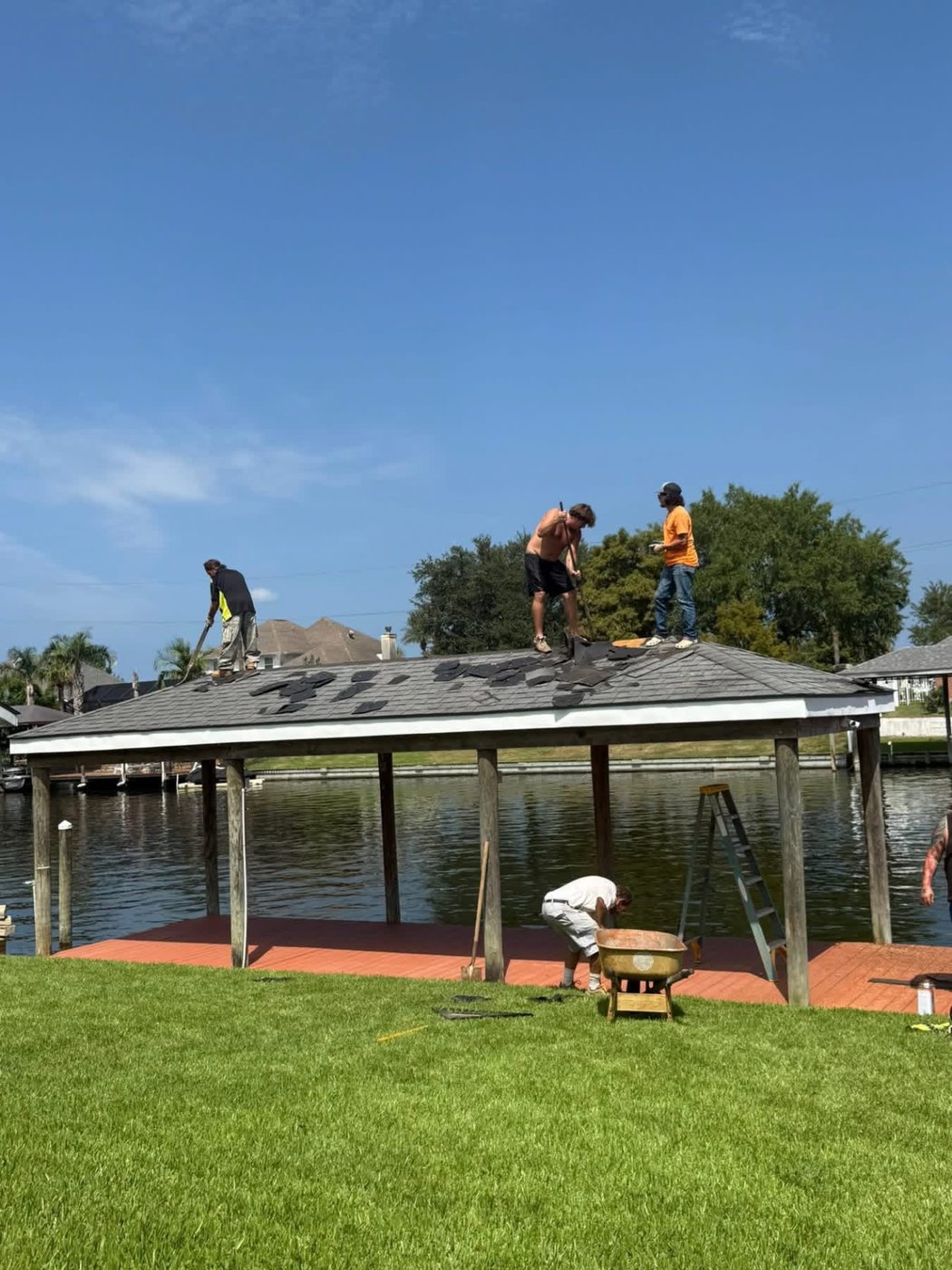 Crew removing the roof of an over-water dock
